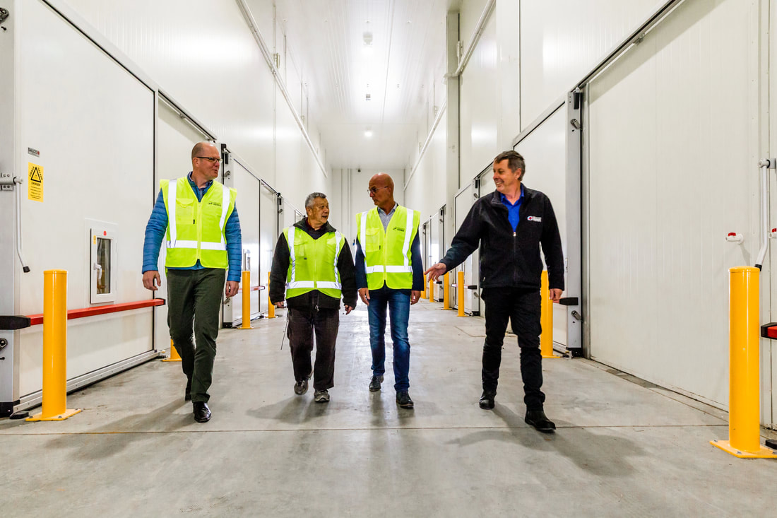 Picture of men walking along corridor in storage facility