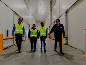Picture of group in hi-viz walking along corridor